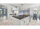 Bright kitchen with granite counters, a center island, stainless steel refrigerator, and marble patterned flooring at 2347 123Rd E Pl, Parrish, FL 34219
