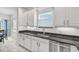 Modern kitchen with white cabinets, stainless steel appliances, and granite countertops at 2347 123Rd E Pl, Parrish, FL 34219