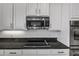 Close-up of kitchen with granite counters, white cabinets, and stainless steel microwave and oven at 2347 123Rd E Pl, Parrish, FL 34219