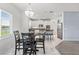 Bright eat-in kitchen with a modern chandelier, bar stool seating, and access to the main kitchen area at 2347 123Rd E Pl, Parrish, FL 34219