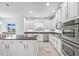 Modern kitchen featuring white cabinets, granite countertops, and stainless steel appliances at 2347 123Rd E Pl, Parrish, FL 34219