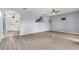 Open living room with wood floors, a ceiling fan, and entry to the foyer with view of the front door at 2347 123Rd E Pl, Parrish, FL 34219