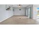 Spacious living room with light-toned wood floors, ceiling fan, and sliding doors leading to the patio at 2347 123Rd E Pl, Parrish, FL 34219