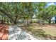 Scenic view of park grounds with a walking path, mature trees, and a covered picnic area at 2347 123Rd E Pl, Parrish, FL 34219