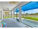 Covered patio with fan overlooking the backyard and water views at 2347 123Rd E Pl, Parrish, FL 34219
