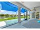 Covered patio features shade-providing screen and view of the back yard and pond at 2347 123Rd E Pl, Parrish, FL 34219