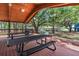 Covered picnic area featuring metal picnic tables, with views of the surrounding park at 2347 123Rd E Pl, Parrish, FL 34219
