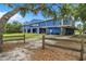 Exterior of large blue storage facility with multiple garage doors and a gravel parking area at 2347 123Rd E Pl, Parrish, FL 34219