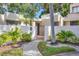 Inviting home featuring gated courtyard, lush tropical landscaping and a curved walkway to the entrance at 2383 Lakeside Mews # D3, Sarasota, FL 34235