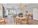 Cozy living room with high ceilings, a decorative chandelier and a view of the connected dining room and Primary bedroom at 2383 Lakeside Mews # D3, Sarasota, FL 34235