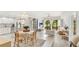 Bright living room with an open floor plan, seamlessly connecting the dining area and a view of the green outdoors at 2383 Lakeside Mews # D3, Sarasota, FL 34235