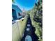 Landscaped backyard with a stone pathway and a green privacy hedge at 2607 29Th W Ave, Bradenton, FL 34205