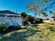 Spacious backyard featuring green grass, mature trees, and a white fence at 2607 29Th W Ave, Bradenton, FL 34205