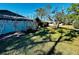 Expansive green backyard with trees, a white fence, and sunny skies at 2607 29Th W Ave, Bradenton, FL 34205