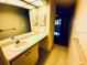 Bathroom featuring a vanity with a sink, mirror, and storage cabinets at 2607 29Th W Ave, Bradenton, FL 34205