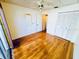 Bedroom features hardwood floors, a closet, a mirror, and a fan at 2607 29Th W Ave, Bradenton, FL 34205