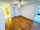 Bright bedroom with polished hardwood floors, ceiling fan, and closet space at 2607 29Th W Ave, Bradenton, FL 34205