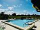 Community pool with chairs and tables in the background. Open sky and lawn visible at 2607 29Th W Ave, Bradenton, FL 34205