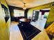 View of the dining area with table, chairs, and access to the front entry at 2607 29Th W Ave, Bradenton, FL 34205