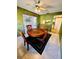 Dining room with four chairs, tiled floor, and view into kitchen and living areas at 2607 29Th W Ave, Bradenton, FL 34205