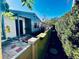 Side view of a cottage with a colorful garden, fence, and stone pathway at 2607 29Th W Ave, Bradenton, FL 34205