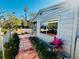 Charming home featuring a tile path, lush landscaping, and a large window at 2607 29Th W Ave, Bradenton, FL 34205