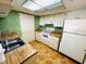 The kitchen has white appliances, wooden countertops, and ample storage at 2607 29Th W Ave, Bradenton, FL 34205