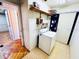 A utility room with a dryer and shelving for extra storage at 2607 29Th W Ave, Bradenton, FL 34205