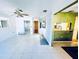 Open living area featuring tile floors, a ceiling fan, and a view into other rooms at 2607 29Th W Ave, Bradenton, FL 34205