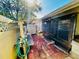 Outdoor patio featuring brick flooring, a covered picnic table, and an entryway into the home at 2607 29Th W Ave, Bradenton, FL 34205