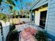 A quaint tiled patio showcasing lush landscaping and a secure entry door at 2607 29Th W Ave, Bradenton, FL 34205