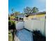 Cozy patio area featuring a white privacy fence, gate, and concrete walkway at 2607 29Th W Ave, Bradenton, FL 34205