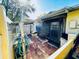 Outdoor patio featuring brick flooring, a covered picnic table, and an entryway into the home at 2607 29Th W Ave, Bradenton, FL 34205