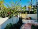Charming patio with a paver walkway, vibrant greenery, and white privacy fence at 2607 29Th W Ave, Bradenton, FL 34205