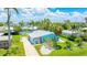 Aerial shot of a turquoise house with mature palms and a well-manicured front yard at 2713 Avenue C, Holmes Beach, FL 34217