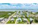 Aerial view showcases home's location in a waterfront community with stunning bay views and a serene residential neighborhood at 2713 Avenue C, Holmes Beach, FL 34217