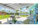 Spacious outdoor patio features a grill, dining table and seating, perfect for outdoor dining and entertainment at 2713 Avenue C, Holmes Beach, FL 34217