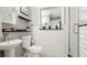 Charming bathroom with white subway tile walls, floating shelves and a glass shower at 2713 Avenue C, Holmes Beach, FL 34217