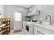Clean and organized laundry room featuring front load washer, dryer and storage at 2713 Avenue C, Holmes Beach, FL 34217
