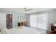 Serene bedroom featuring a large window, a ceiling fan, and neutral decor at 2713 Avenue C, Holmes Beach, FL 34217