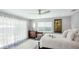 Serene bedroom featuring a large window, a ceiling fan, and neutral decor at 2713 Avenue C, Holmes Beach, FL 34217