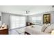 Serene bedroom featuring a large window, a ceiling fan, and neutral decor at 2713 Avenue C, Holmes Beach, FL 34217