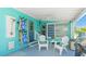 Inviting patio with seating, outdoor shower, grill, and beach chairs, perfect for relaxing and entertaining at 2713 Avenue C, Holmes Beach, FL 34217