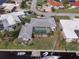 Aerial view of a home with a screened-in pool and boat dock, positioned along a waterway in a waterfront community at 2807 Coral Way, Punta Gorda, FL 33950