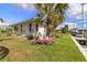 Backyard with a grassy lawn and waterfront access, featuring comfortable seating with decorative cushions at 2807 Coral Way, Punta Gorda, FL 33950