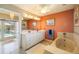 Bathroom featuring double vanity sinks, a bathtub, and access to the pool area at 2807 Coral Way, Punta Gorda, FL 33950