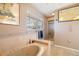 Bathroom with marble-style finishes, a bathtub, and a glass-enclosed shower at 2807 Coral Way, Punta Gorda, FL 33950