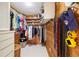 Walk-in closet with wooden walls, white shelving, and clothing on hangers at 2807 Coral Way, Punta Gorda, FL 33950