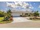 Charming one-story home with a tile roof, two-car garage, and lush tropical landscaping at 2807 Coral Way, Punta Gorda, FL 33950