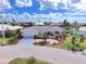 Charming home featuring a well-manicured lawn, tasteful landscaping, and a welcoming yellow-painted front door at 2807 Coral Way, Punta Gorda, FL 33950